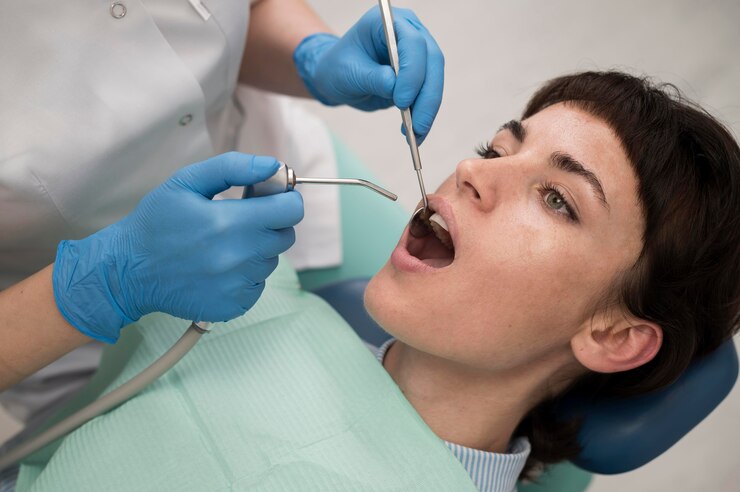 Young female patient having dental procedure at the orthodontist<br />
